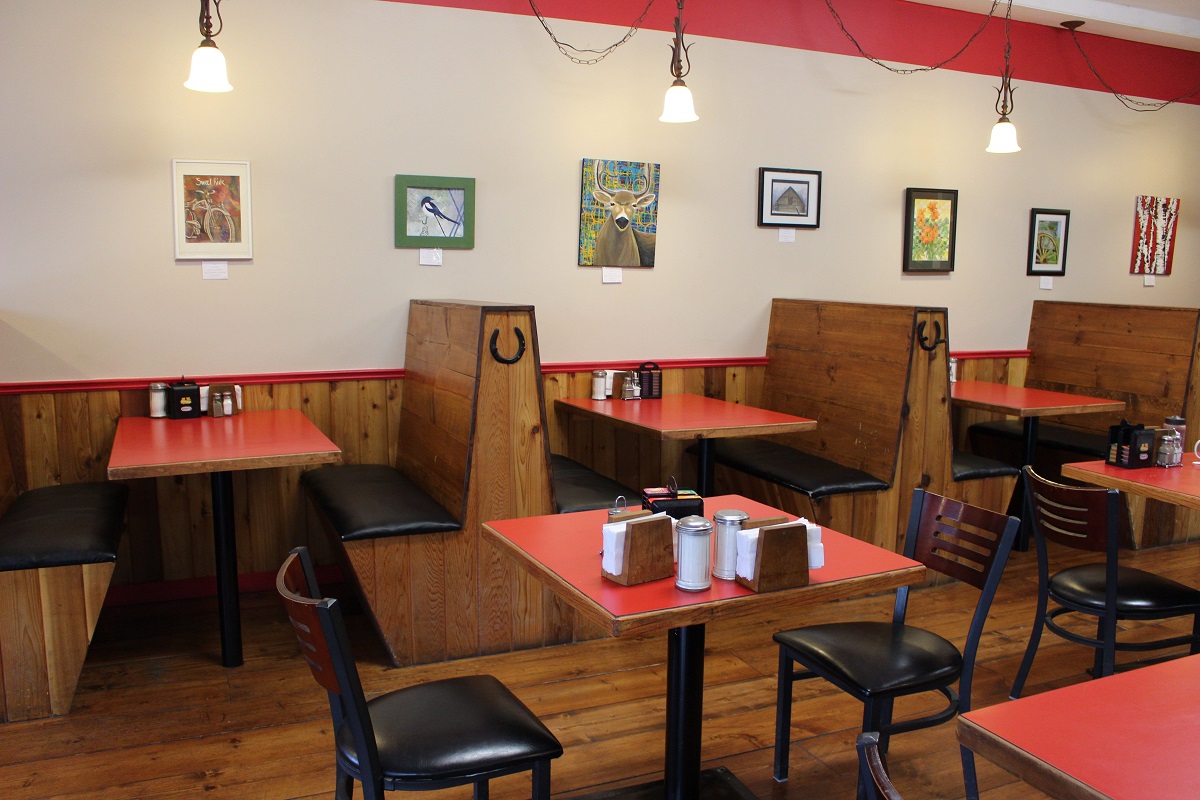 Casual diner interior with red tables and booths